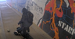 Agresīvais vīrietis stāv pie piekautā vīrieša.