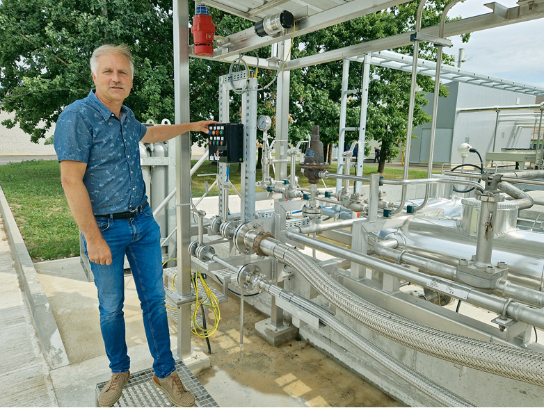 Enerģētikas nodaļas vadītājs Andris Ramons biometāna rūpnīcā vietā, kur biometānu sašķidrinātā veidā sūknē cisternā vešanai uz Vāciju.