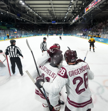 Latvijas hokeja izlases spēlētāji Zemgus Girgensons (nr. 28, baltā tērpā) un Dans Ločmelis (nr. 11, baltā tērpā) hokeja priekšsacīkšu spēlē starp Latvijas un Vācijas valstsvienībām "Milānas Rho arēnā" Milānā 2026. gada Milānas un Kortīnas ziemas olimpiskajās spēlēs Itālijā.