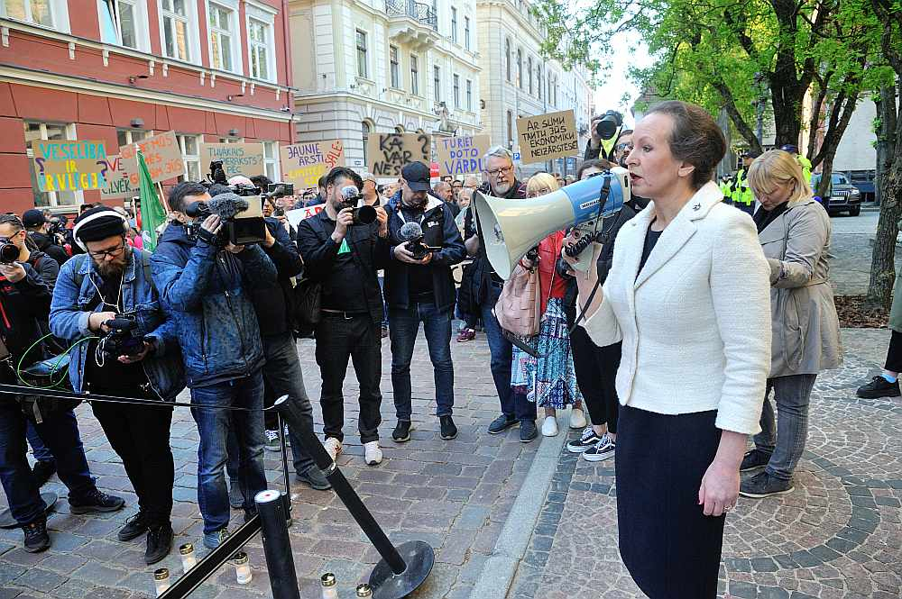 Citi ministri aicina veselības ministri Līgu Meņģelsoni raudzīties, "kā katrs eiro iedos ieguvumu iedzīvotājiem veselības uzlabošanai", jo nauda daudzāc citām valsts iestādēm esot "nogriezta ļoti sāpīgās vietās". Attēlā: veselības ministre L. Meņģelsone 11. maijā uzrunā mediķu protesta akcijas dalībniekus pie Saeimas nama.