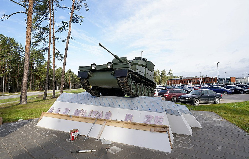 Kadagā pie Nacionālo bruņoto spēku NBS militārās bāzes uz podesta izvietotais kāpurķēžu bruņutransportieris.