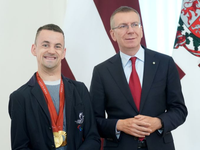Valsts prezidents Edgars Rinkēvičs (no labās) un Parīzes paraolimpisko spēļu divu zelta medaļu ieguvējs paraiejādē parasportists Rihards Snikus.
