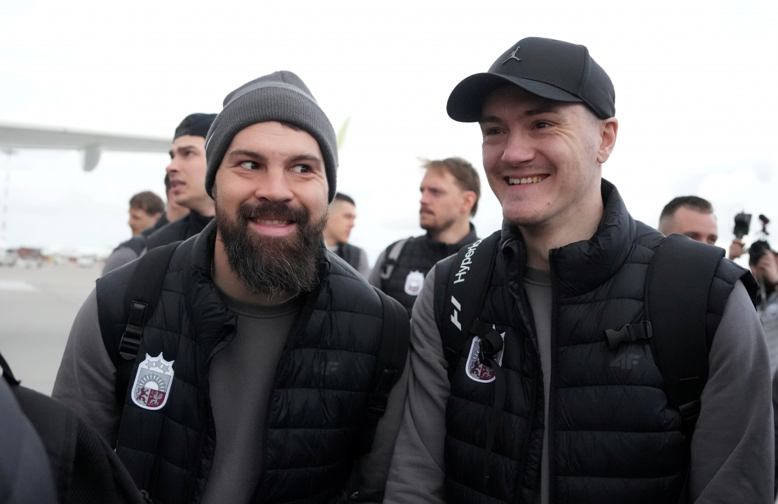 Latvijas hokeja izlases spēlētāji Kaspars Daugaviņš (no kreisās) un Kristaps Roberts Zīle Rīgas lidostā pirms došanās uz 2025. gada pasaules hokeja čempionātu Stokholmā.