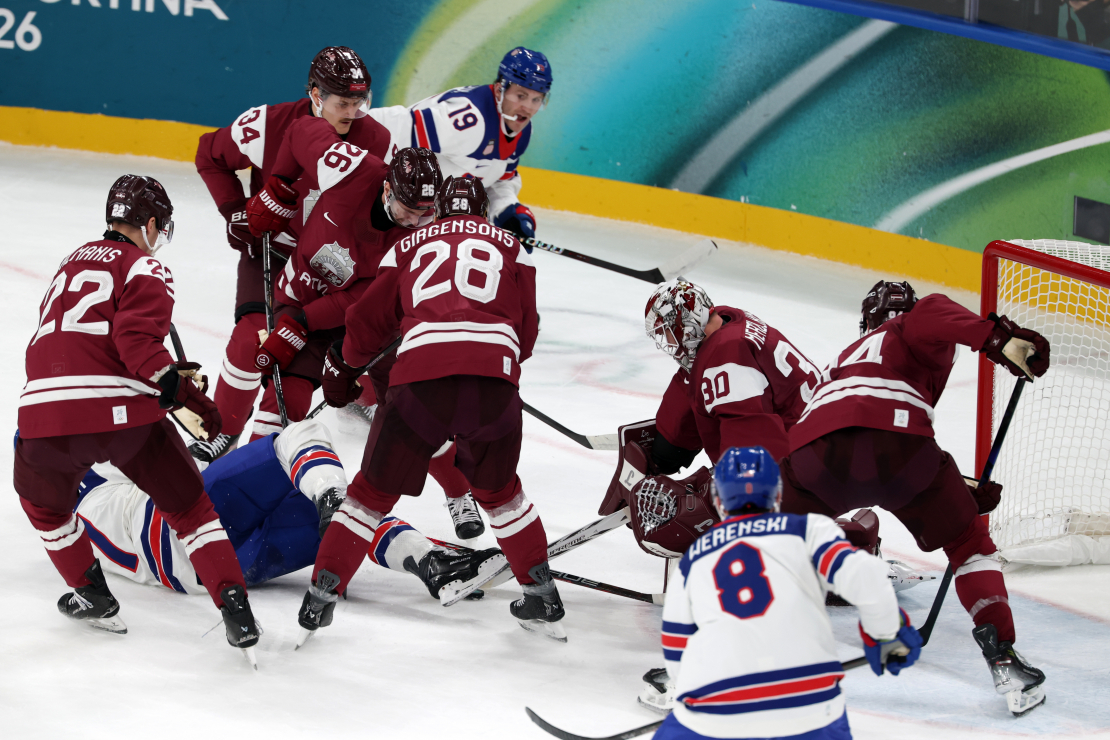 Hokeja priekšsacīkšu spēle starp Latvijas un ASV valstsvienībām Santagiulia ledus hokeja arēnā Milānā 2026. gada Milānas un Kortīnas ziemas olimpiskajās spēlēs Itālijā.