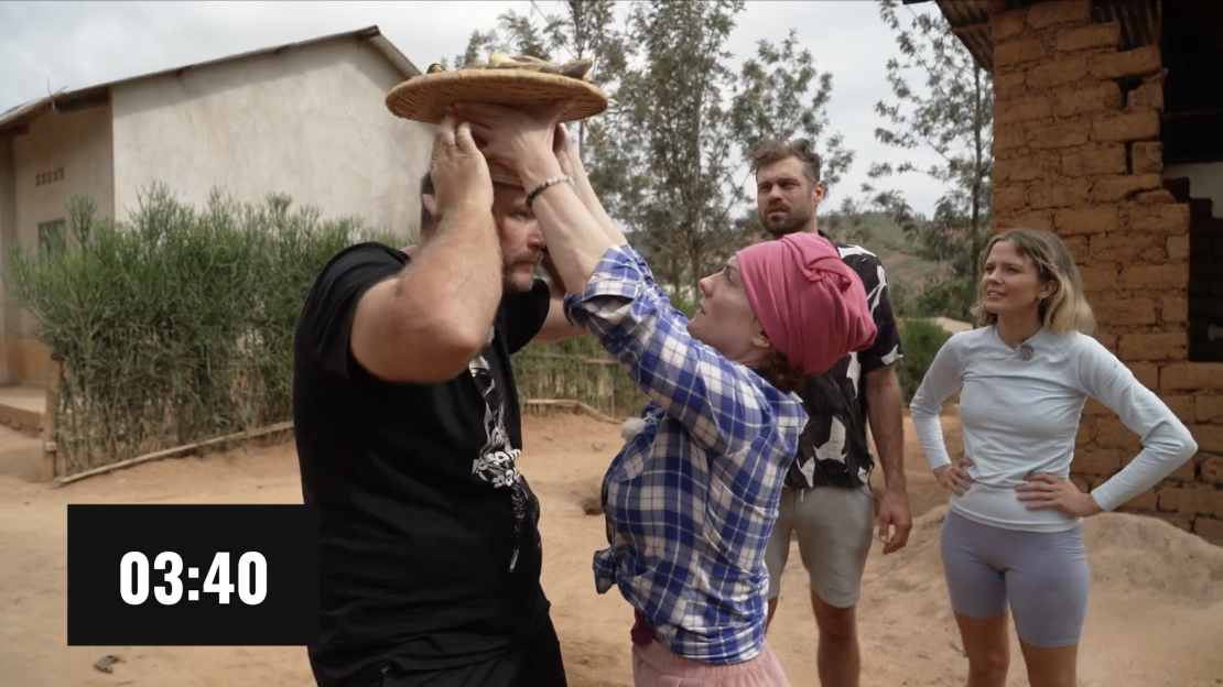 "Četri uz koferiem" iemēģina spēkus banānu nešanā uz galvas.