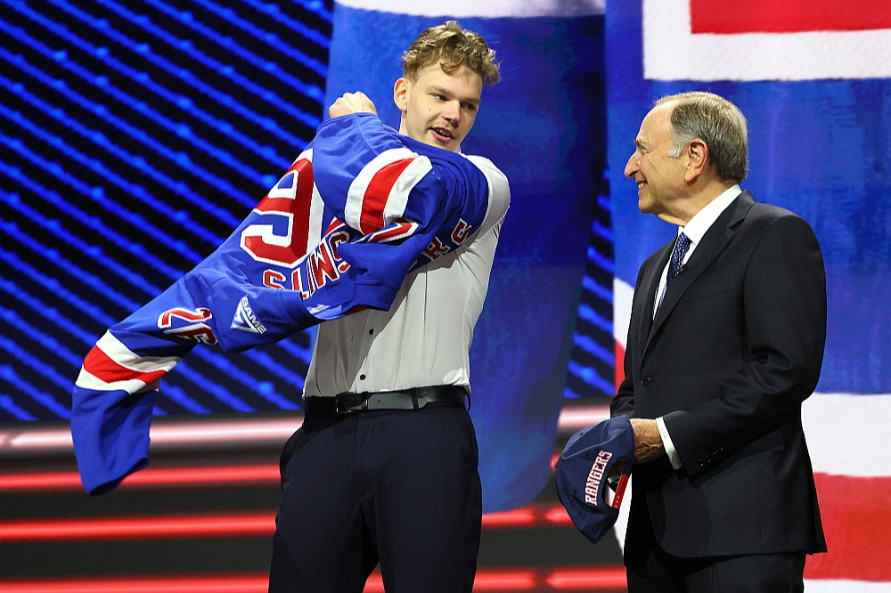 Alberts Šmits (no kreisās), pirmo reizi mugurā velkot Ņujorkas "Rangers" kreklu, pārmij frāzes ar NHL galveno vīru – līgas komisāru Geriju Betmenu.