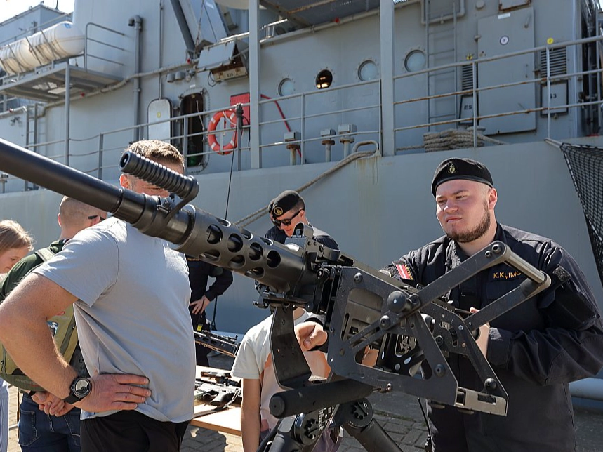 NATO ships and equipment docked at a passenger port.