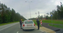 Ropažu novada pašvaldības policijas darbinieki pie apturētā auto.