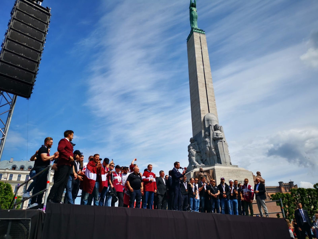 Cilvēki pie Brīvības pieminekļa sagaida hokeja varoņus.