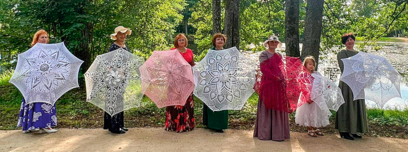 Baltie un krāsainie saulessargi uz Jaunlaicenes gleznainās muižas fona.